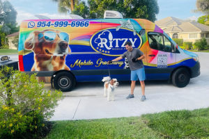 A happy man and his happy dog after a pet mobile grooming service